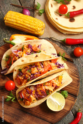 Mexican food tacos, fried chicken, greens, mango, avocado, pepper, red cabbage