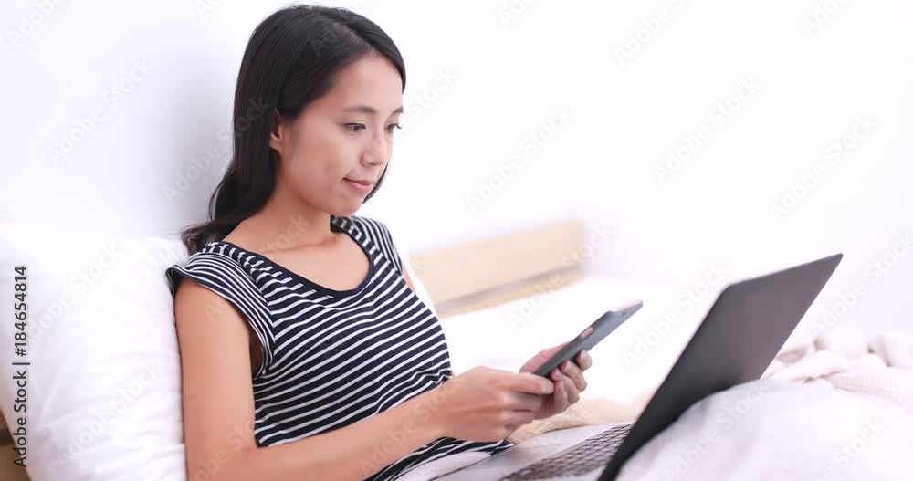 Woman pay with cellphone on laptop computer for online shopping Woman pay with cellphone on laptop computer for online shopping