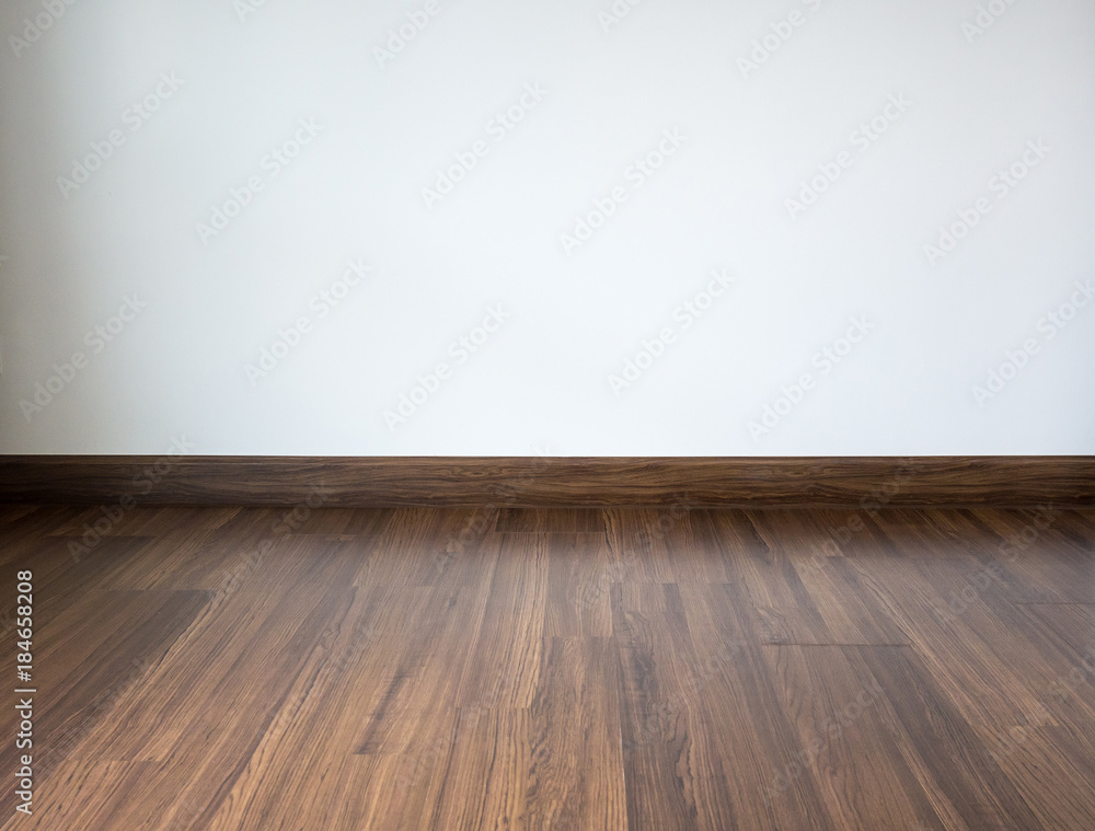 Empty room with laminate floor and white wall background