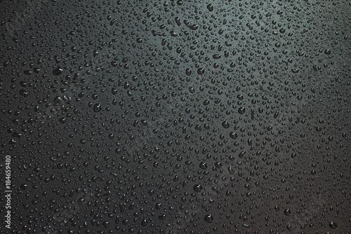 Small liquid drops on a black background. photo