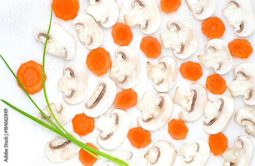 Sliced mushrooms, carrot, black pepper and green onion on white background