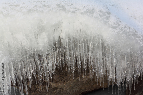 Fototapeta Naklejka Na Ścianę i Meble -  Icicles on a stone on a freezing river  , Ob reservoir, Siberia, Russia