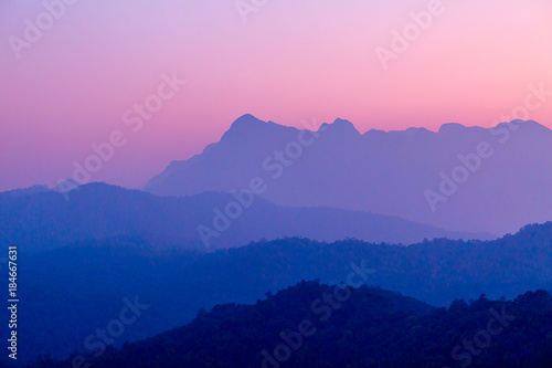 Landscape of mountain layer in morning sunrise and winter fog