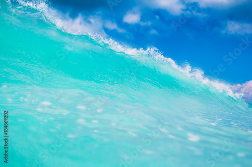 Blue or turquoise ocean wave. Clear wave in tropics and blue sky