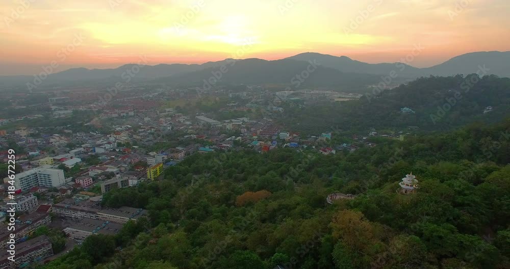 aerial view during sunset at Khao Rang the landmark viewpoint of Phuket place in the central of Phuket town. on Khao Rang viewpoint can see Phuket city to Chalong pier and Phuket big Buddha on hilltop aerial view during sunset at Khao Rang the landmark viewpoint of Phuket place in the central of Phuket town. on Khao Rang viewpoint can see Phuket city to Chalong pier and Phuket big Buddha on hilltop