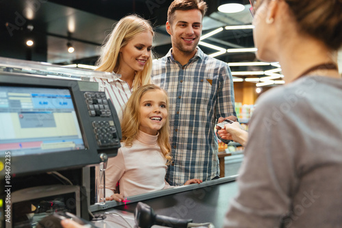 Young family paying with a credit card