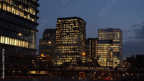 Traffic, trains and offices at night in the business district called 'Zuidas' in Amsterdam. photo