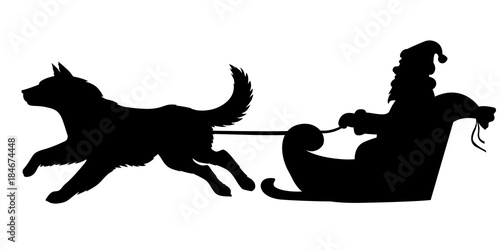 Silhouette Santa riding on dogs sleigh