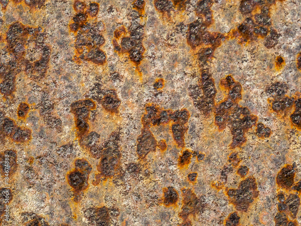 Fragment of an iron wall covered with corrosion Fragment of an iron wall covered with corrosion