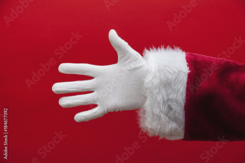 Santa Claus hand against a red background
