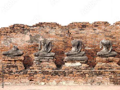 ancient ruin buddha sculpture with brick wall background in Ayutthaya, Thailand
