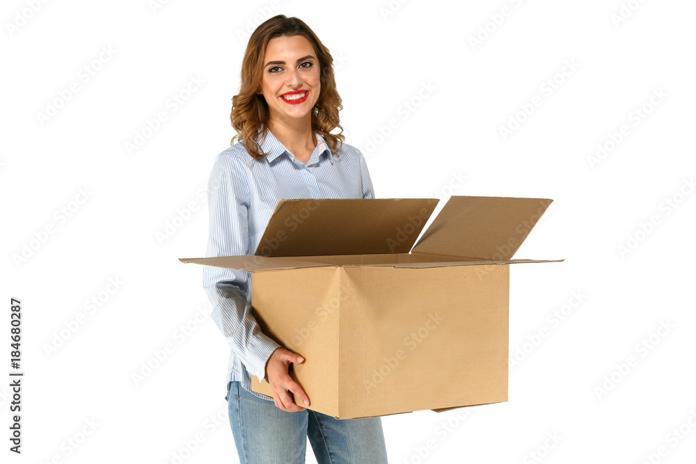 Attractive smiling girl holding big opened cardboard box in her hands wearing blue shirt and jeans, on white background Attractive smiling girl holding big opened cardboard box in her hands wearing blue shirt and jeans, on white background