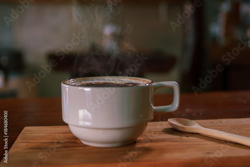 Cup of coffee on wooden dable in the coffee shop. photo