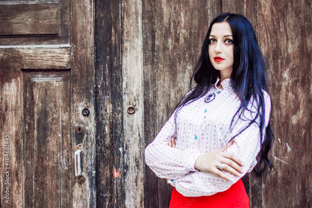 Fototapeta premium .A pretty girl in a red skirt poses