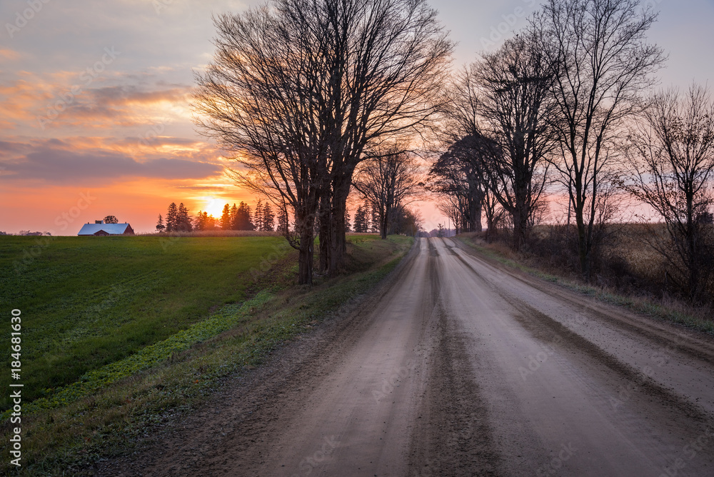 Majestic Sunset over a Tree Lined Unmade Back Road in the Countryside of Ontario, Canada Majestic Sunset over a Tree Lined Unmade Back Road in the Countryside of Ontario, Canada