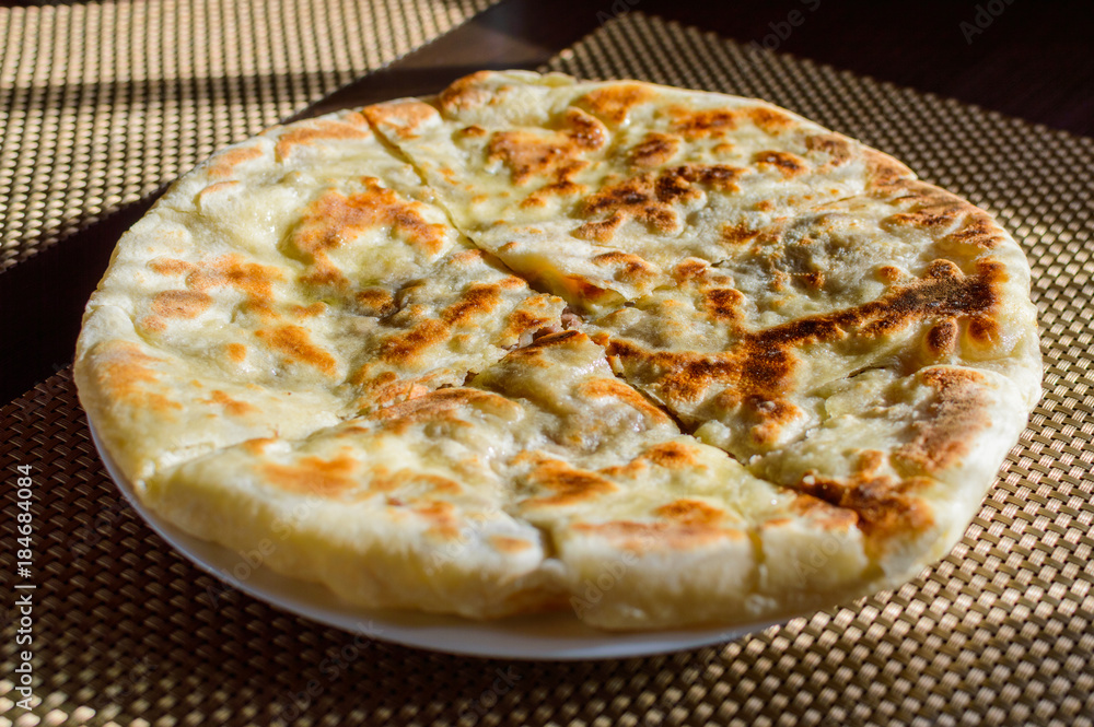 Hychin bread pie with potato stuffing. Traditional Caucasian cuisine - hot Ossetian pie