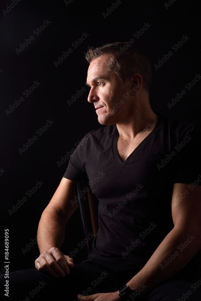 Naklejka premium portrait of a man on black background