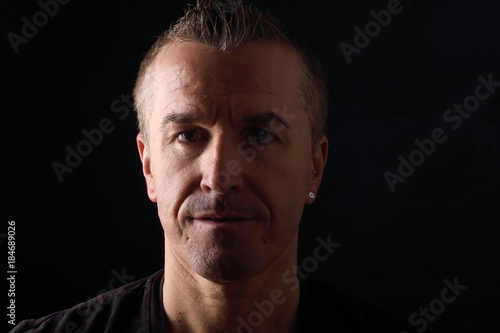 portrait of a man on black background © curto