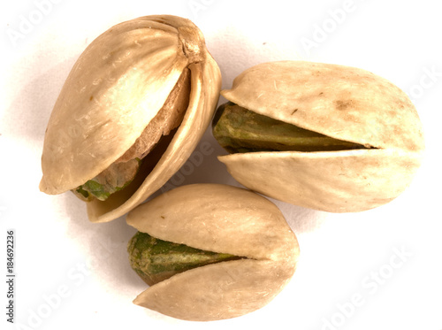 Macro view of three pieces of pistachio nut
