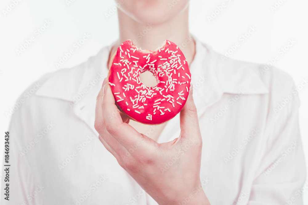 cropped shot of woman holding bitten glazed doughnut cropped shot of woman holding bitten glazed doughnut