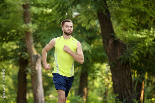 Sporty young man running in...