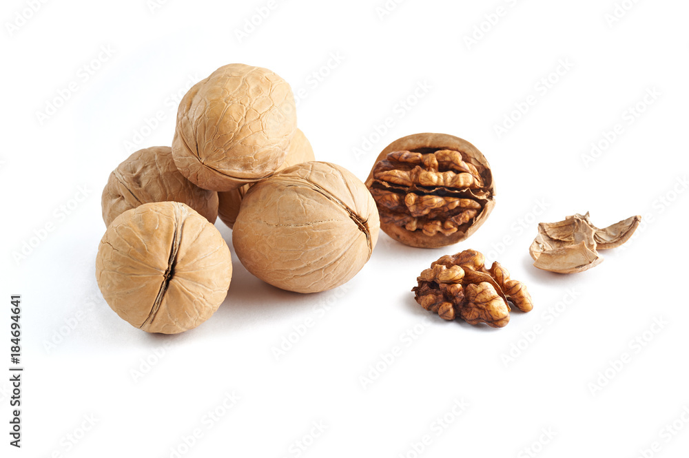Walnuts and walnuts kernels with shell crumbles isolated on white background. Walnuts and walnuts kernels with shell crumbles isolated on white background.