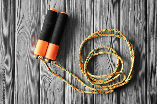 Jumping rope on wooden background