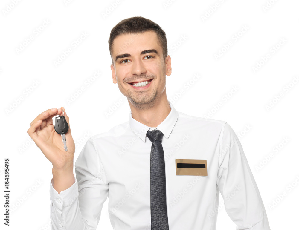 Attractive salesman holding car key on white background Attractive salesman holding car key on white background