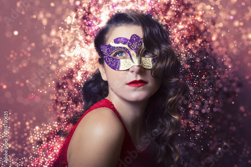 Beautiful Woman wearing a Carnival Mask. Halloween holiday concept.