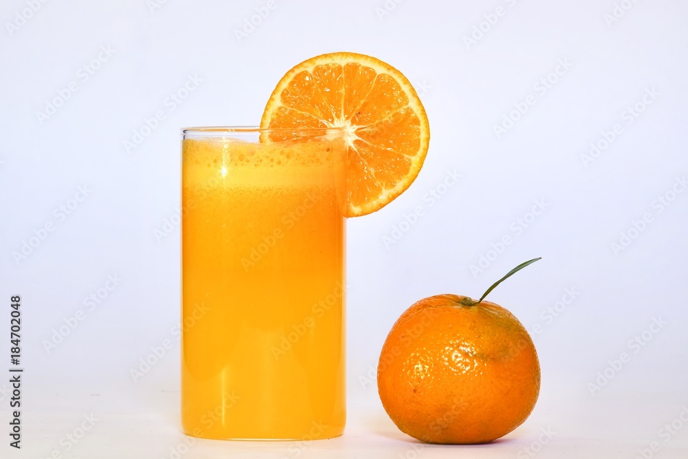 Natural Orange juice filled in a glass with a slice of orange Natural Orange juice filled in a glass with a slice of orange