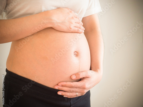pregnant woman holds her hands on her belly.maternity concept.Belly of pregnant woman with hands. © Surajet.L