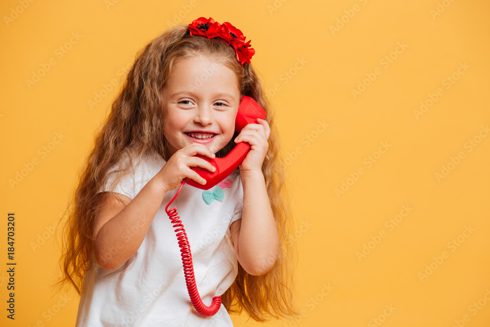 Cheerful pretty girl talking by telephone. Cheerful pretty girl talking by telephone.