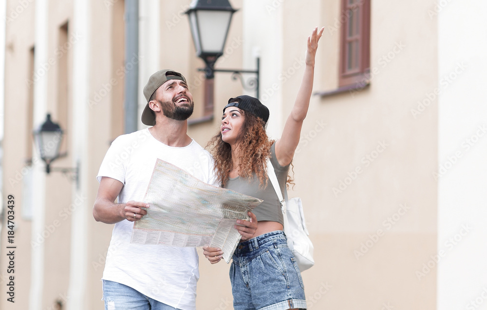 Young tourist couple with map looking for a way