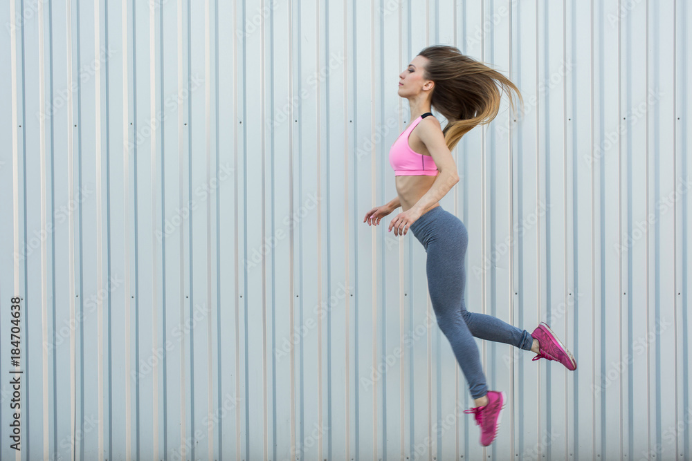 Fitness sport girl in fashion sportswear dancing hip hop in the street, outdoor sports, urban style Fitness sport girl in fashion sportswear dancing hip hop in the street, outdoor sports, urban style