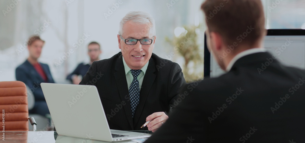Business partners discussing in meeting hall with their collegue Business partners discussing in meeting hall with their collegue