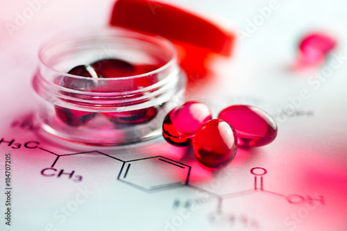 Painkiller tablets - pink caps with molecules chemical formulas - healthcare and medicine photo