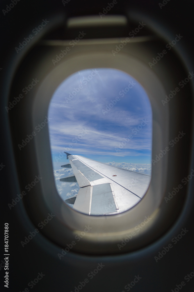 Wing of an airplane flying above the clouds look from cabin window. Wing of an airplane flying above the clouds look from cabin window.