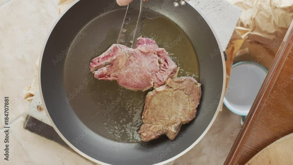 Veal cottletes sizzling in a pan Veal cottletes sizzling in a pan