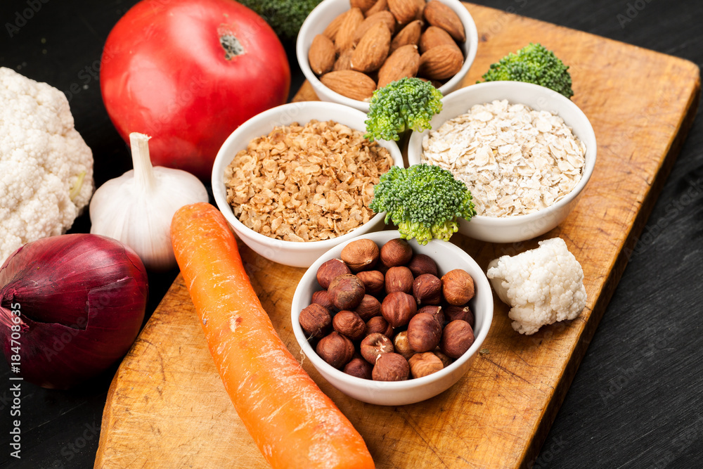Fresh raw vegetables with nuts and cereals for cooking or eating. Vegetarian food. Top view