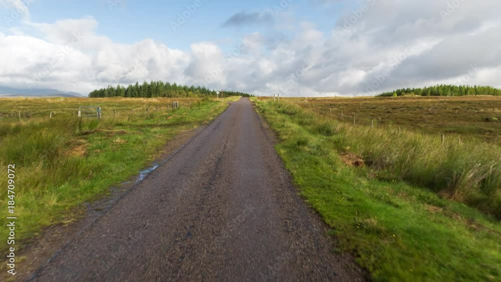POV shot from a camera attached to the front of a vehicle driving through beautiful empty roads in the scottish highlands POV shot from a camera attached to the front of a vehicle driving through beautiful empty roads in the scottish highlands