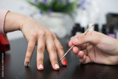 Closeup shot man making manicure to woman in beauty salon