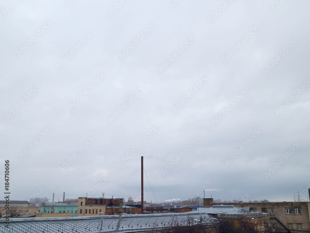 view of city industrial zone, winter evening, gray sky strong wind