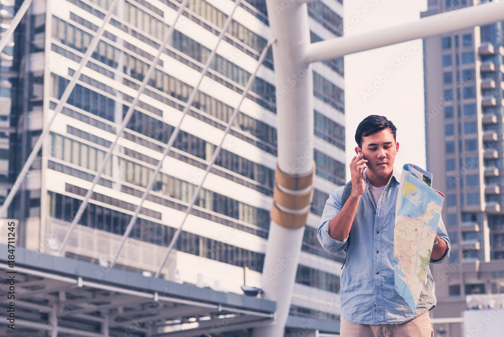 Tourists searching place on map,and using smartphone talk to consul for help Tourists searching place on map,and using smartphone talk to consul for help