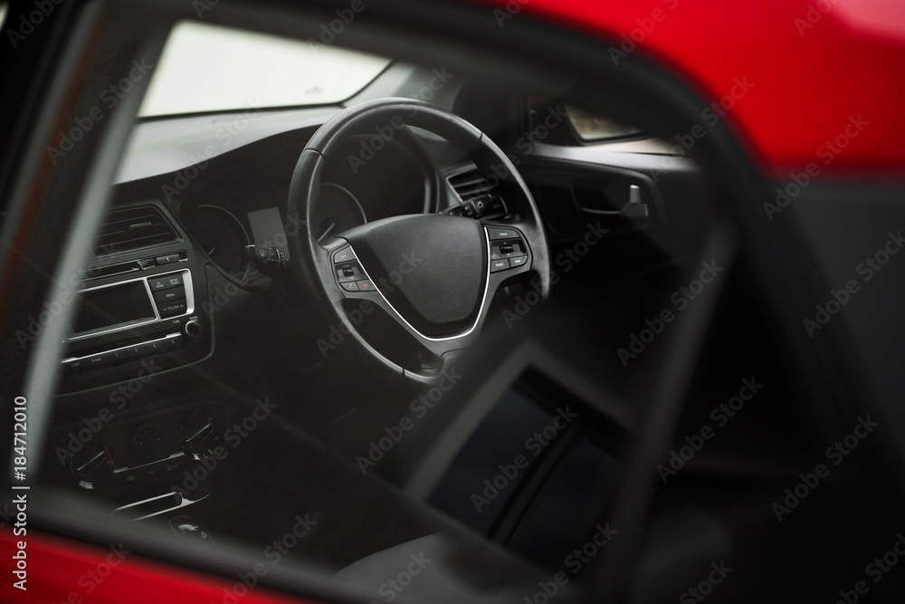 Interior view of car with black interior through the glass.