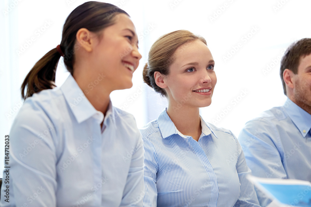 group of smiling businesspeople meeting in office group of smiling businesspeople meeting in office