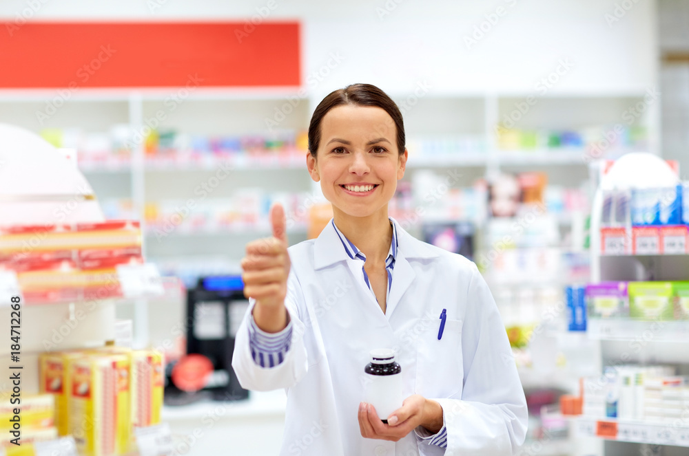 apothecary with drug showing thumbs up at pharmacy