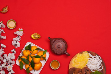 celebrate Chinese New Year background with orange fruit for warship, red envelope and beautiful blossom.