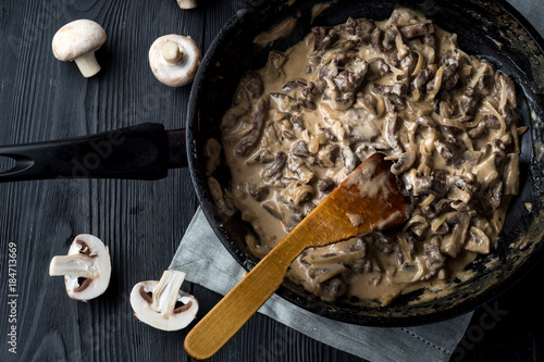 Metal skillet beef stroganoff in a thick with mushrooms