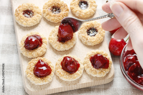 Puff pastry cookies filled with cherry jam.