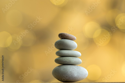 Harmony and balance stack of smooth white pebbles on Christmas reflections background